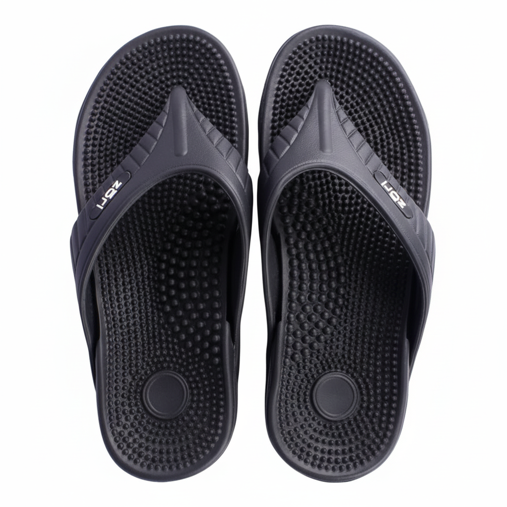 Pair of black massage sandals with textured soles on a white background