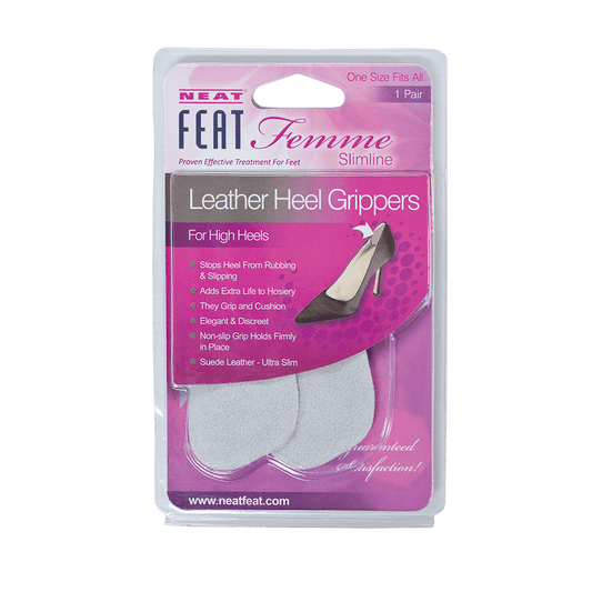 Neat Feat Femme Leather Heel Grippers, in mostly pink packaging with mostly white text, featuring a clear plastic cover that exposes the light grey grippers inside. The front includes an image of a shoe showing where to install the grippers for added comfort and support.